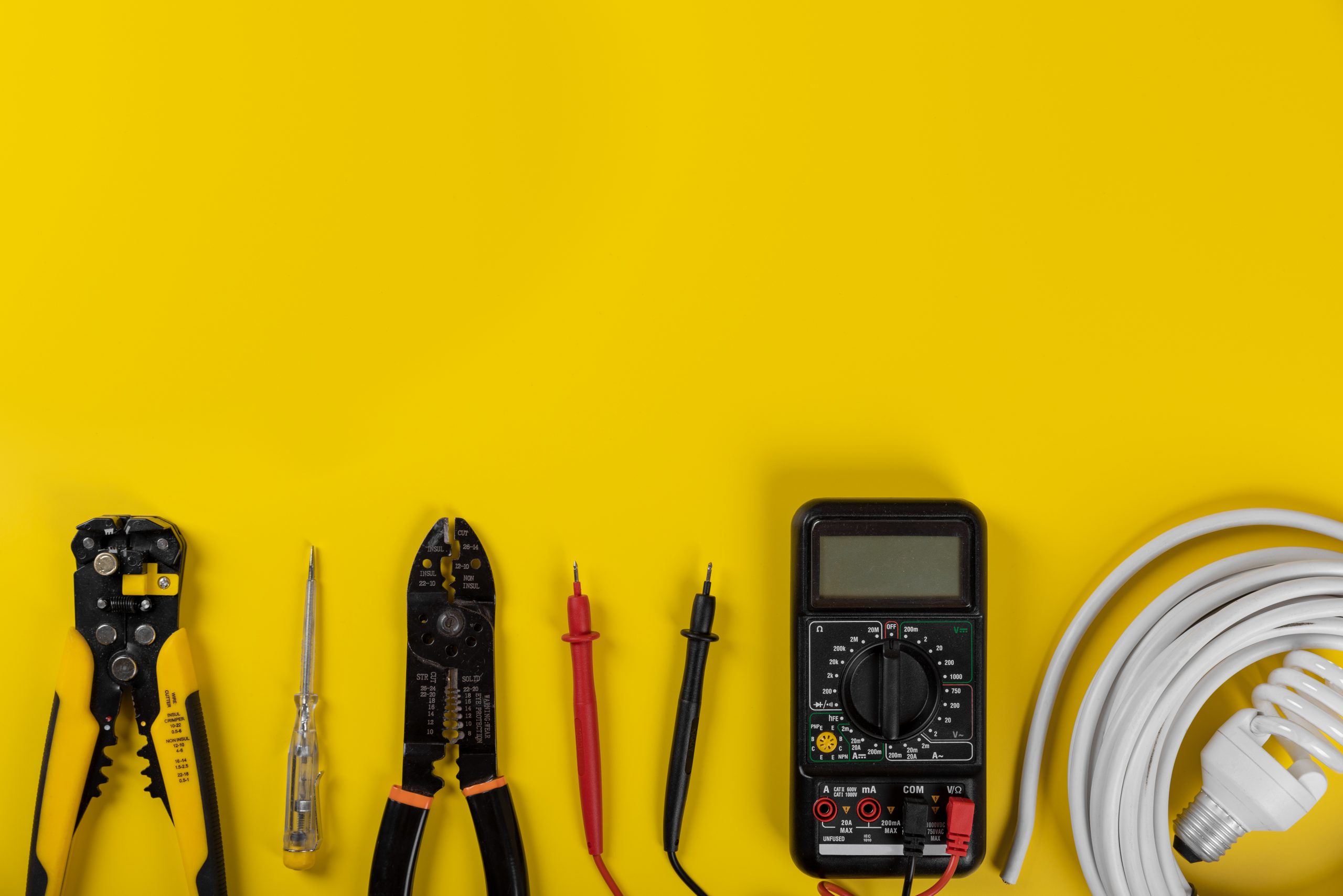electrical installation tools on yellow background with copy spa